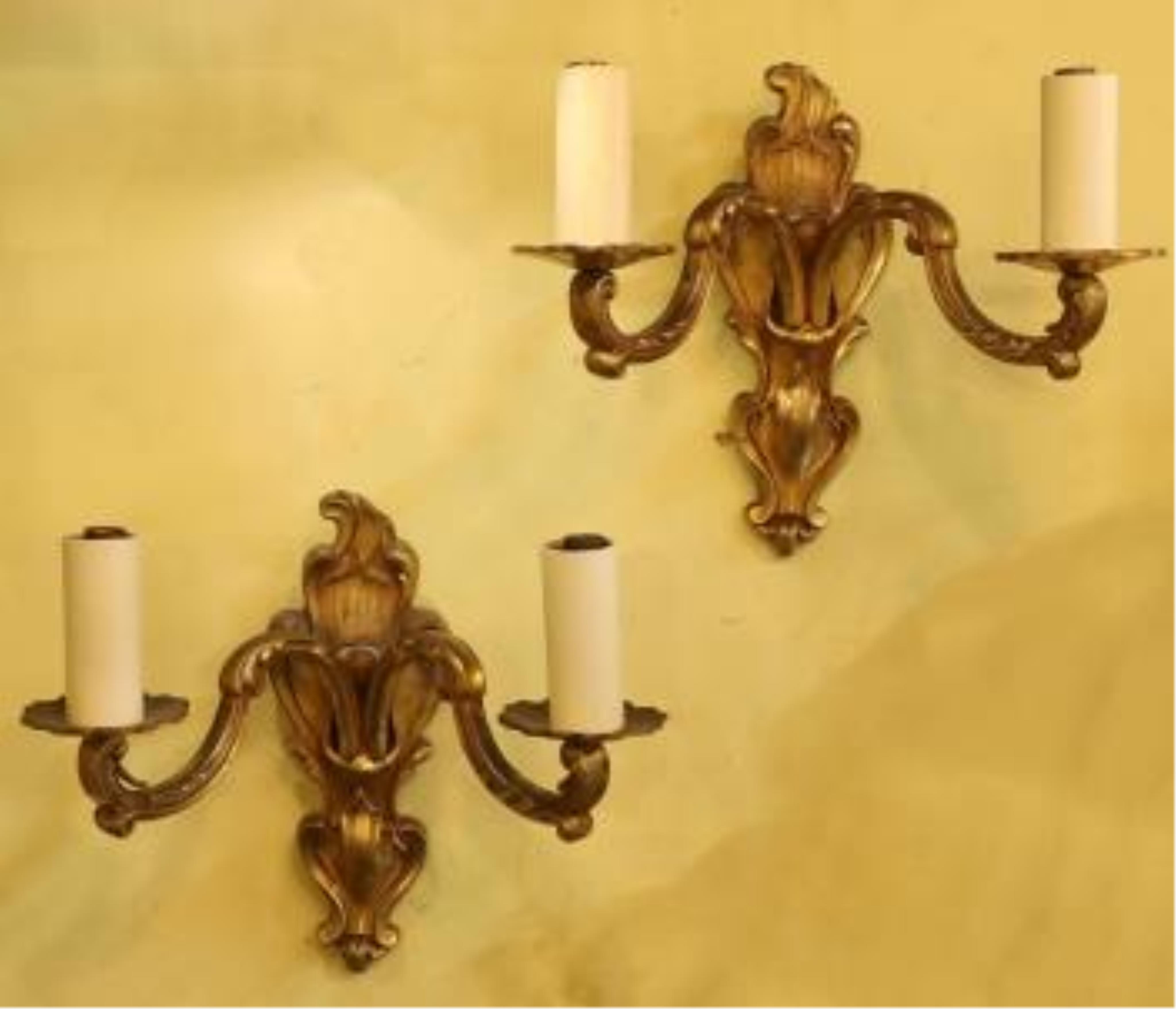 A pair of late 19th century French ormolu twin branch wall lights, 21cm high. Condition - fair to good